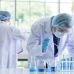 Federal Scientists Accused of Smuggling Virus Samples on Flight Scientists working in a laboratory with test tubes
