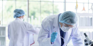 Scientists working in a laboratory with test tubes