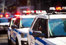 NBA Finals Game Brings NYC Security Perimeter Police cars with flashing lights in line formation.