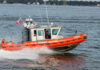 Coast Guard boat speeding on the water.