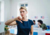 No FISA Renewal Without Voter ID — Standoff Woman with thumbs down in voting location.