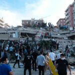 A Miracle: Baby Pulled Alive From Earthquake Rubble People at a collapsed building after an earthquake.