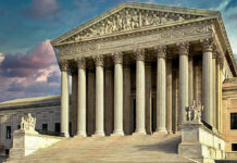 SIJS Program Faces Scrutiny Building with columns and statues in front of entrance.