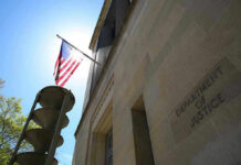 American flag at Department of Justice building exterior.