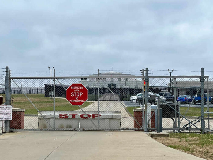 2375002113-2 Chain-link fence with Restricted Area Stop No Photography sign.