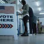 One election night revealed a growing rebellion Sign reading Vote Here in a polling station.
