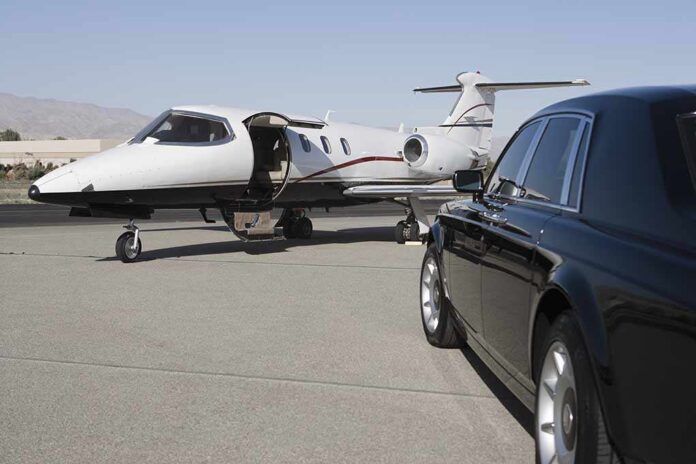 Limousine,And,Private,Jet,On,Landing,Strip A private jet parked at an airport with a luxury car in the foreground
