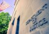 Former CIA Executive Held in Scandal Case Exterior view of the Department of Justice building with an American flag