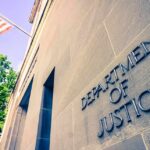 Former CIA Executive Held in Scandal Case Exterior view of the Department of Justice building with an American flag