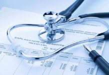 A stethoscope resting on a medical billing statement