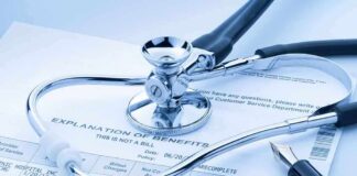 A stethoscope resting on a medical billing statement
