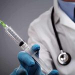 The Catch: Routine Test Reveals Hidden Iron Disorder A doctor holding a syringe with a stethoscope around their neck