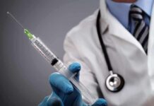 The Catch: Routine Test Reveals Hidden Iron Disorder A doctor holding a syringe with a stethoscope around their neck