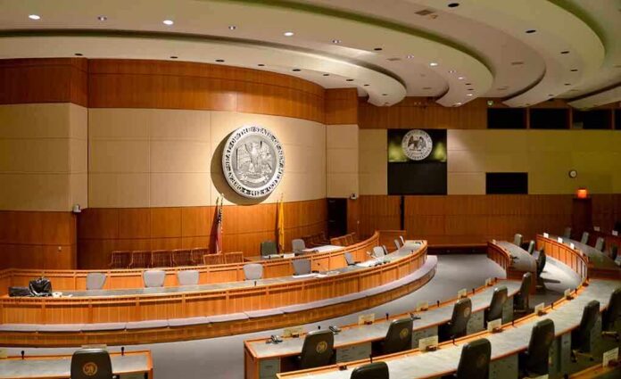 shutterstock_190351604-1 Interior view of a government chamber with wooden paneling and seating