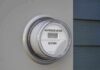 Blame Game Over Bills Explodes Digital electric meter displaying energy consumption
