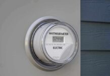 Blame Game Over Bills Explodes Digital electric meter displaying energy consumption