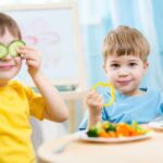 Thousands Of Texts — Toddlers Targeted Two children playing with vegetables while enjoying a meal