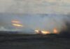 A tank firing in a smoky battlefield during a military exercise