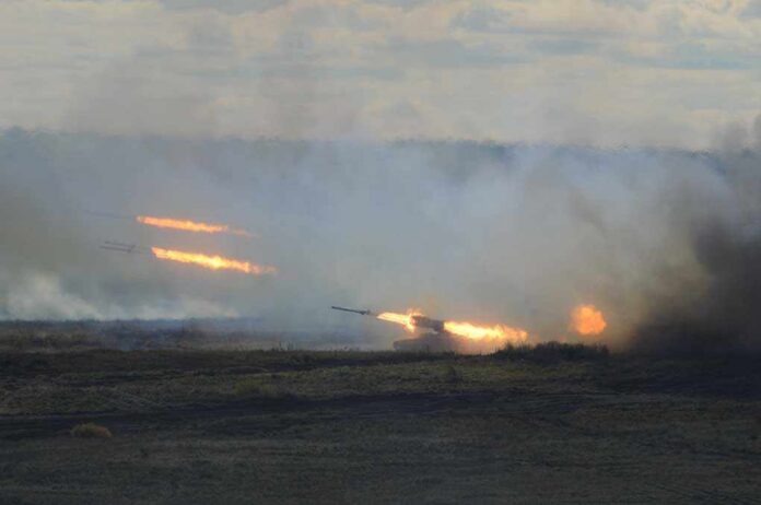 Volley,Fire A tank firing in a smoky battlefield during a military exercise