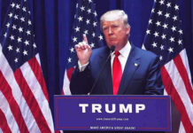 “Nobody Can Be Like Us”: Trump’s Boldest America 250 Message Yet Man speaking at podium with USA flags behind him.