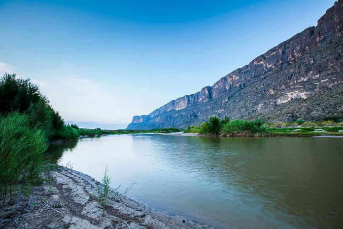 1625919589 River with mountains and greenery in the background.