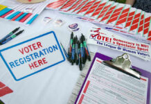 One Governor Can Now Handpick a U.S. Senator—Voters Have No Say Voter registration table with forms, pens, and brochures.