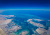 China’s Next Power Move May Not Require a Single Shot Aerial view of coastline and ocean.