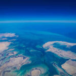China’s Next Power Move May Not Require a Single Shot Aerial view of coastline and ocean.