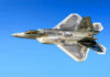 Air Force Fast-Tracks F-47 as F-22 Rumors Swirl Fighter jet in flight against a clear blue sky.