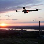 New Patriot Interceptor Targets Drones, Rockets—and Sky-High Defense Costs Drones flying over a river landscape at sunset