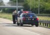 Police Camera Program Suspended Police officer conducting a traffic stop on a highway