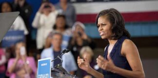 A female speaker passionately addressing a crowd at a campaign event