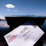 The Legal War Over Mail-In Voting Is Far From Over Mail-in ballot being inserted into a blue USPS mailbox