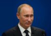 Russia Invites Talks, Ukraine Rejects Moscow Venue A political figure speaking at a press conference against a blue background