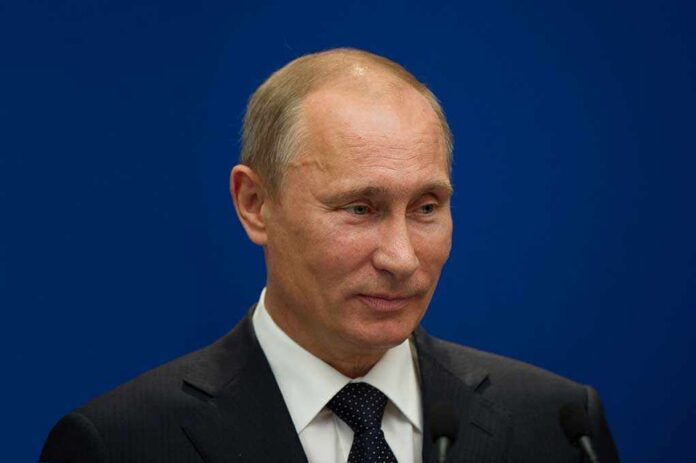 Paris,-,June,21,:,Vladimir,Putin,During,A,Work A political figure speaking at a press conference against a blue background