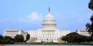 View of the U.S. Capitol building with a security barrier in front