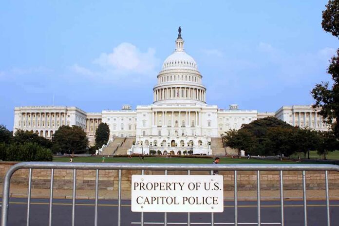 shutterstock_1913280-1 View of the U.S. Capitol building with a security barrier in front