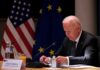 Pressure, Diplomacy, and No Clear Endgame elderly man at conference table with flags in background