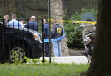 FBI Investigates Fiery Attack Outside New York law enforcement officers gather at taped-off outdoor scene