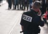 Cops Doubt: Teen’s Final Pleas Captured on Bodycam Police officer in uniform communicating with a crowd in an urban setting