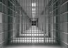 empty prison corridor with barred cells