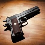Black handgun on wooden surface
