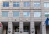 H-1B Visa Fraud Probe Targets Wage Abuse US government building facade with flags and number 500