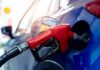 Lawsuit Alleges 1 Million Gallons Of Fuel Went Unpaid Red gasoline nozzle fueling a blue car
