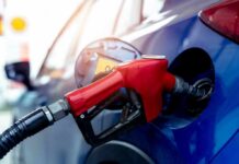 Lawsuit Alleges 1 Million Gallons Of Fuel Went Unpaid Red gasoline nozzle fueling a blue car