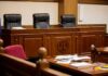 empty courtroom with judge's bench and microphones