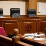 Ukraine Aid Faces Growing Fraud Concerns empty courtroom with judge's bench and microphones