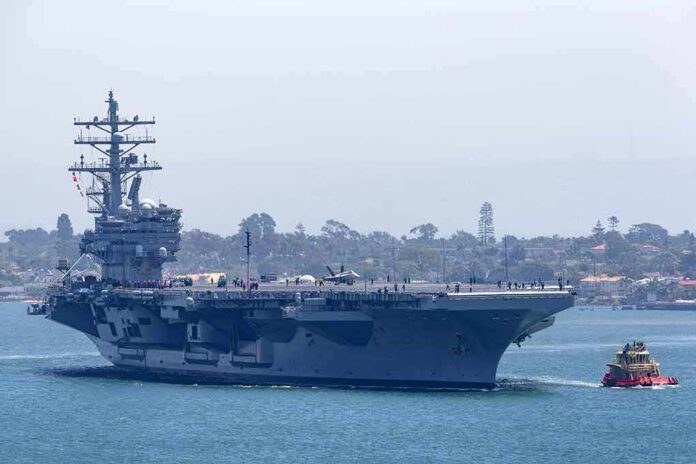 shutterstock_1926504035 Aircraft carrier escorted by a tugboat in a harbor