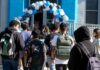 Dual-Enrollment Controversy Explodes Students with backpacks enter a school under a balloon arch