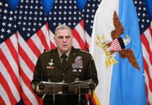 War Ethic That Still Haunts Marines Military officer speaks at podium with U.S. flags behind